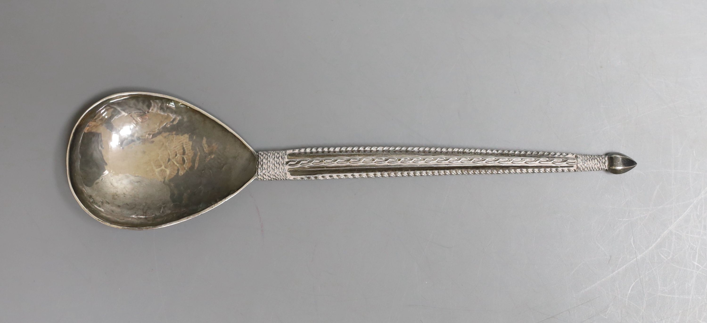 A George V Arts & Crafts silver spoon by The Artificers' Guild Ltd, with planished bowl, 15.7cm, 40 grams.